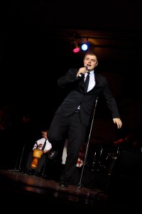 Student singing on stage.